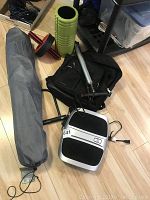 Full overview of all items including folding chair in carry bag, exercise roller, bike pump, bike lock, and foot massager on floor.