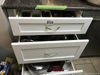 Drawers containing the pots, pans, and lids from Remy Oliver