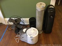 Wide view of all items including the Emerson fan, Sunbeam humidifier, Lasko fan, and two Holmes air purifiers on hardwood floor.