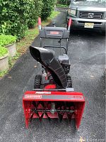 Front view showing red auger housing with Craftsman badge and black augers