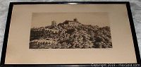Framed ink or pencil drawing showing entire framed artwork depicting a castle on a hill.