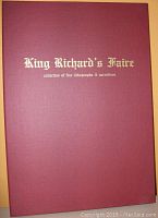 Closed burgundy presentation box with gold embossed text 'King Richard's Faire collection of fine lithographs & narratives' on the front.