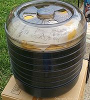 Photo of black Ronco food dehydrator with multiple trays and clear vented lid