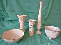 Front view of five Lenox porcelain pieces including two bowls and three vases with clear visibility of shapes and details.