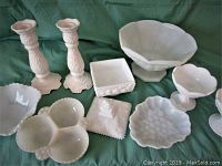 Photo showing entire assortment of nine white milk glass items including 2 candle holders, large and small pedestal bowls, divided serving dish, lidded candy dish, and other decorative bowls.