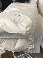 White full size mattress pad folded showing softness and tag