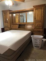 Wide view of assembled solid wood bed frame showcasing mirrored headboard and queen size memory foam mattress.