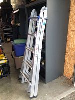 Full view of the Werner telescoping multi ladder in folded position showing aluminum construction and locking mechanisms.