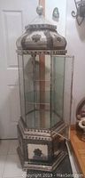 Full view of hexagonal display cabinet showing domed top and glass panels