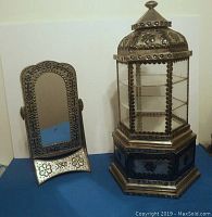 Both tin pressed Mexican vanity mirror and the hexagonal jewelry display case shown side by side