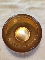 Top view of the golden iridescent glass bowl showing circular shape and color