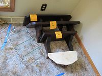 Image showing the collection of five wall shelves: three dark wood shelves, one white stone top semi-circular shelf, and one metal frame shelf with glass panels.