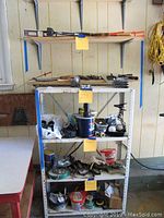 Overview of shelving unit with assorted hardware supplies, tools, containers, and electrical cords