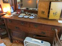 Full view of oak buffet sideboard with mirror and accessories on top