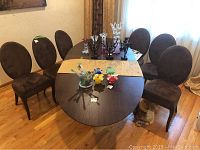Full set of six chairs around dining table on hardwood floor