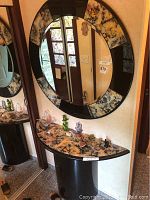 Mirror and hall table showing size and design, mirror mounted on wall above table with decorative patterned frame matching table surface.