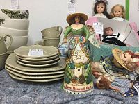 Photo showing Jim Shore garden angel figurine front view, with other items in background for scale.
