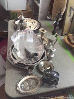 Overview of six assorted pewter and silver plated items including dishes, candlesticks, trays and a trinket box.
