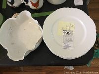 Photo of the vegetable serving bowl and one dinner plate showing scalloped edges and wear on bowl