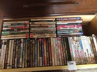 Photo showing a drawer with various DVDs organized upright inside, titles visible include American Movie, Clueless, Bridesmaids, and more.