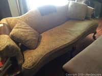 Full left-side view of entire sofa showing camelback profile, upholstery pattern and two toss pillows.