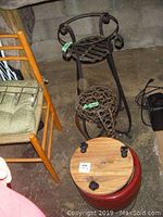 Photo of metal plant stands, Ikea dolly, and red ceramic planter seen from above.