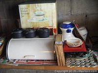 Overview of lot including breadbox, mini cocottes, beverage jar box, snow cone maker, plates and trivets.