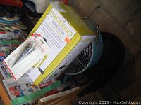 Photo showing Paderno spiral slicer box and metal fan behind