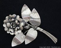Front view of vintage sterling silver rose flower brooch showing detailed petals and leaves.