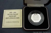 Photo of Certificate of Authenticity booklet and the coin in a protective capsule inside a lined display case.