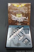 Photo of the boxed Corgi Classics die cast model airplane showing the silver airplane in its plastic tray with missing stand and small model.