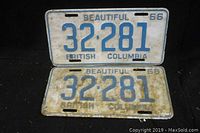 Pair of two 1966 British Columbia license plates with number 32281, plates shown flat on black background.