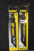 Photo showing two packs of DeWalt branded reciprocating saw blades, yellow/black packaging, front view.