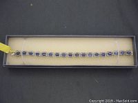 Full length of the silver bracelet showing rectangular blue stones and rhinestones in sterling silver setting.