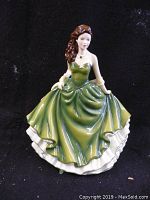 Front view of the Royal Doulton Shauna figurine in green dress on black background.