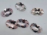 Six oval light peach natural Morganite gemstones shown with mixed modified cut, faceted and transparent, placed on a white background.