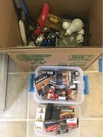 Box with assorted batteries, lightbulbs, fireplace lighters