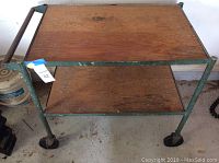 Front view of workshop cart showing wooden shelving and metal frame