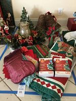 Photo of entire lot showing ceramic tree, grapevine bells, linens, LED light boxes, and stocking.