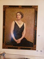 Full front view of the framed oil painting depicting a seated woman in a black dress