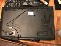 Back view of black Sony LCD TV showing ventilation, power cord, and mounting area.