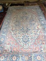 Full view of Karastan wool area rug showing the overall traditional pattern and color scheme.