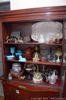 Three-shelf wooden hutch with full lot displayed