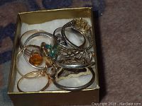 Box of seven assorted rings in sterling silver and gold