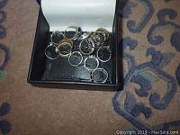 Jewelry box open with assortment of rings inside