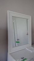 Framed mirror with white wooden frame, size labeled 22x26 inches.