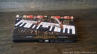 Box of F.A.O Schwarz Giant Dance Mat Piano showing piano keys and foot interaction graphic.