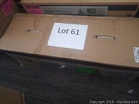 Sealed cardboard box with ‘Lot 61’ label on top