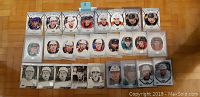 Photo showing 26 Upper Deck Portraits rookie hockey cards laid out in four rows, featuring players including Brady Tkachuk and Clayton Keller.
