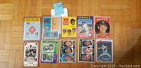 Photo showing 10 vintage baseball cards including 63 Topps E.R.A. Leaders, 61 Topps Strikeout Champions, 62 Topps Clemente Batting Leaders, 74 Ty Cobb Pioneers of Baseball, Don Larsen, Yankees, and others